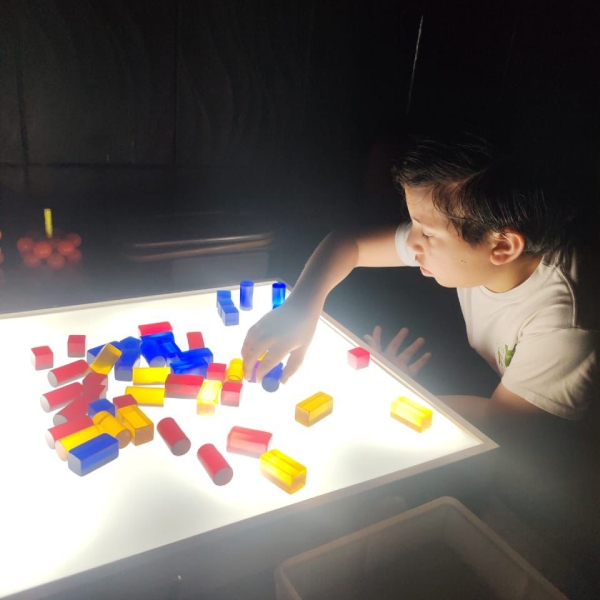 Niño aprendiendo en cuarto oscuro